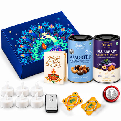A vibrant blue box with a peacock design, two chocolate tins, a Diwali card, six tealights, a remote, two yellow decor