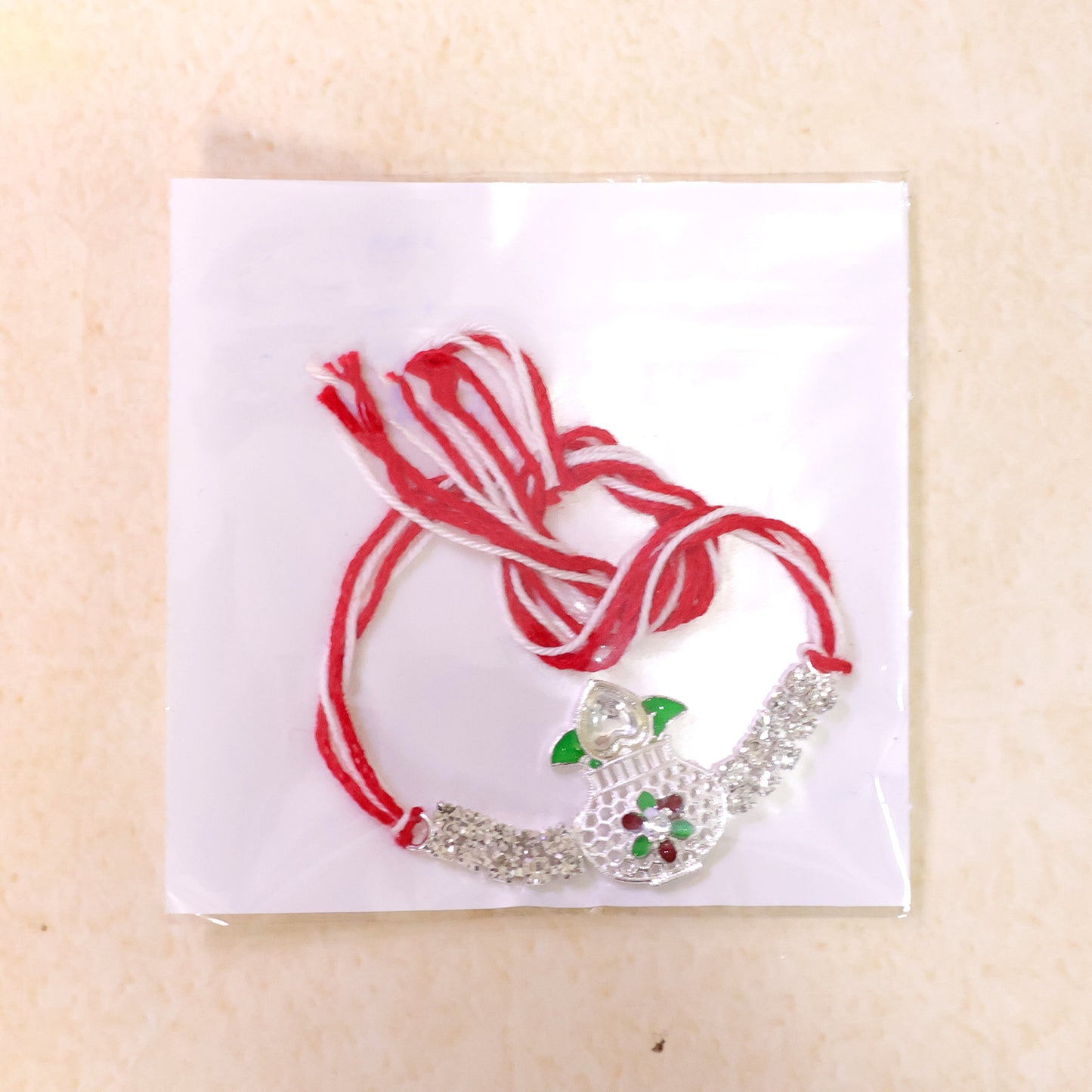 Premium Rakhi showcasing Kalash Charm, gold trims and thread style for Gift Styling