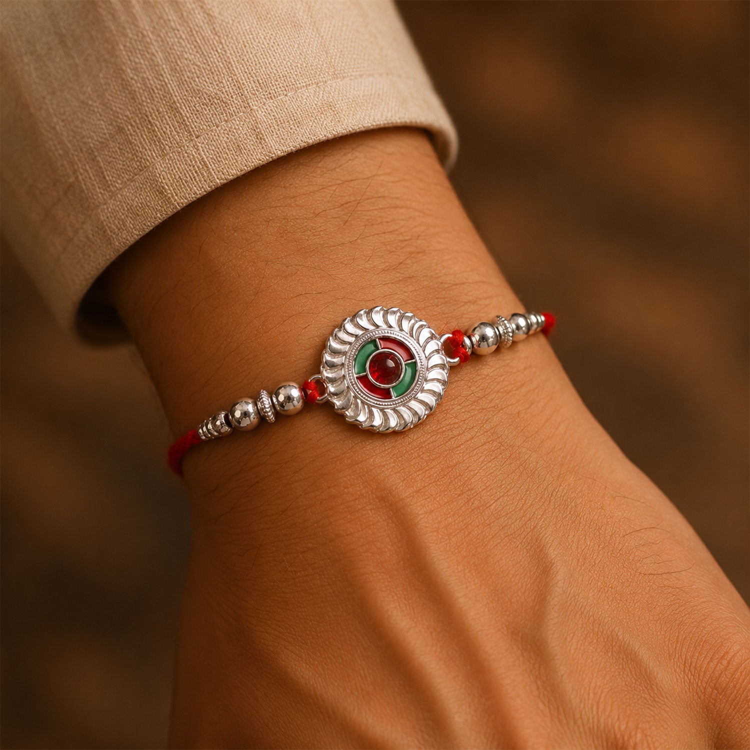 Silver Round Kundan Rakhi with Green Red Center and Metal Beads