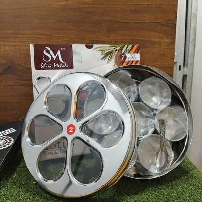 Masala dabba set displayed on kitchen counter with spoon