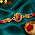 Gold-Toned Radha Krishna Rakhi with Multicolor Enamel, Crystal Accents & Red Thread