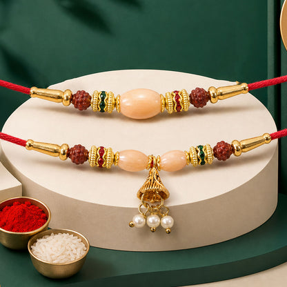 Couple Rakhi with Peach Oval Center Bead and Pearl Drop Charm