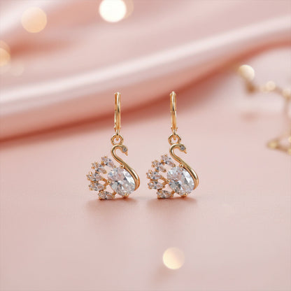 Pair of swan design stone drop earrings with polished finish displayed