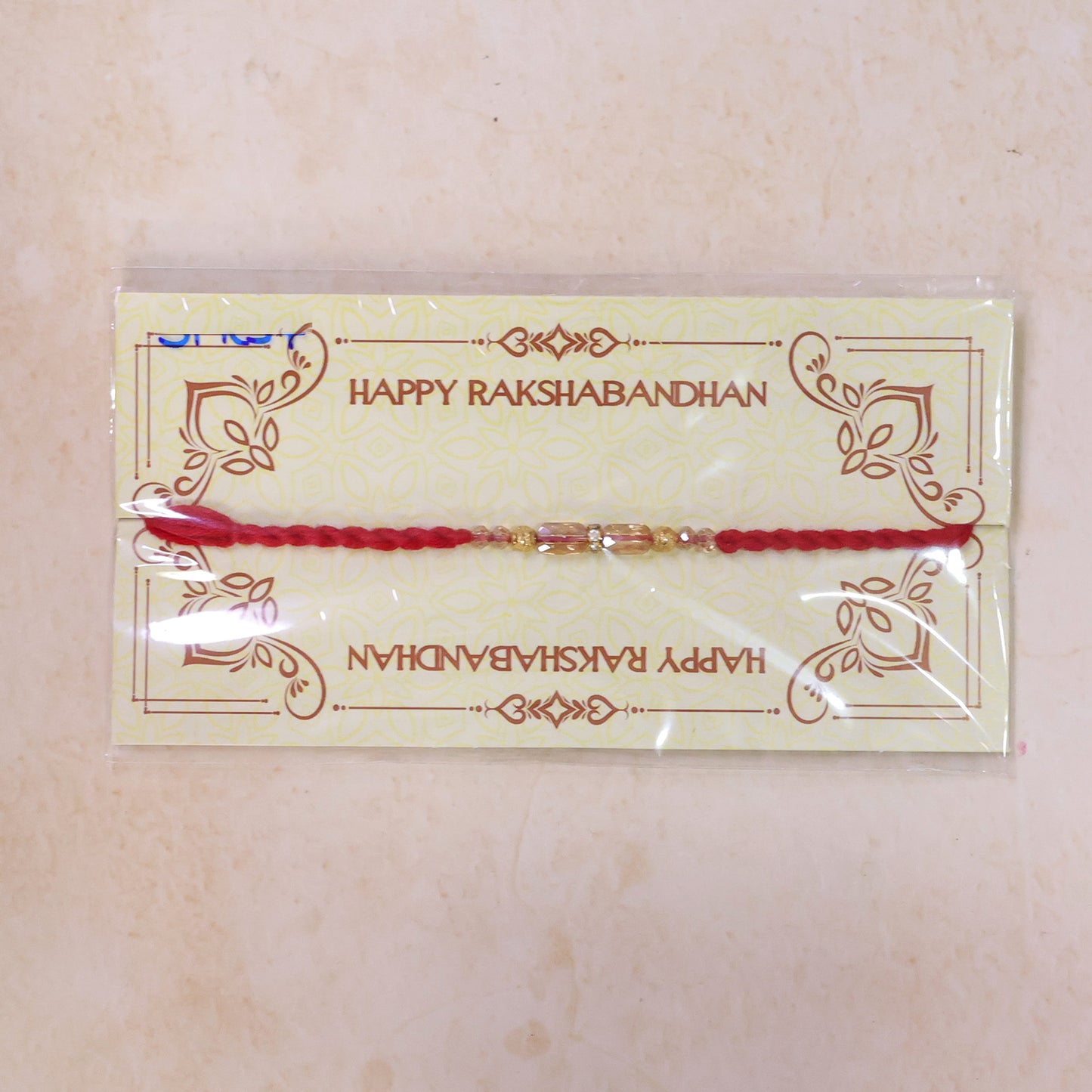 Red Thread Rakhi with Crystal Bead Pendant and Golden Bead Accents