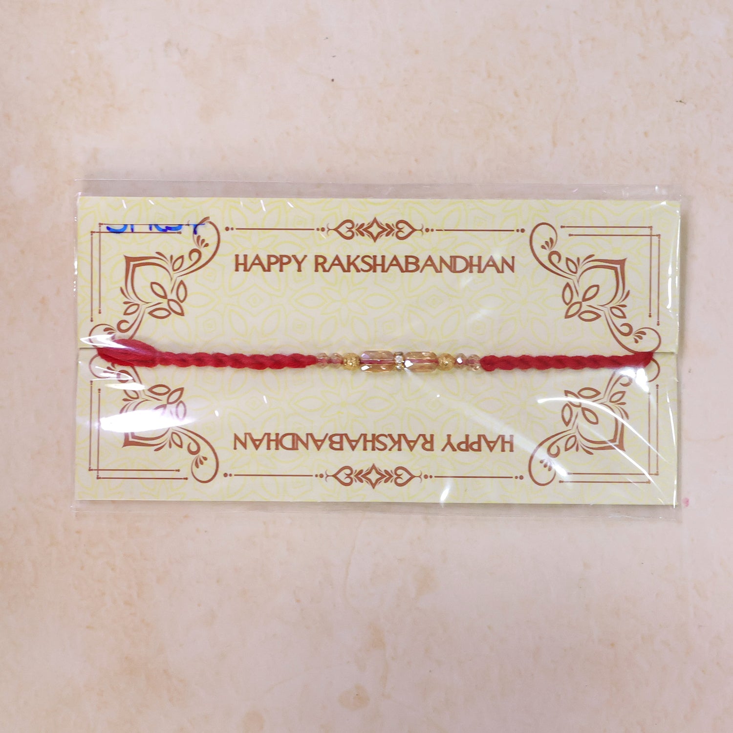 Red Thread Rakhi with Crystal Bead Pendant and Golden Bead Accents