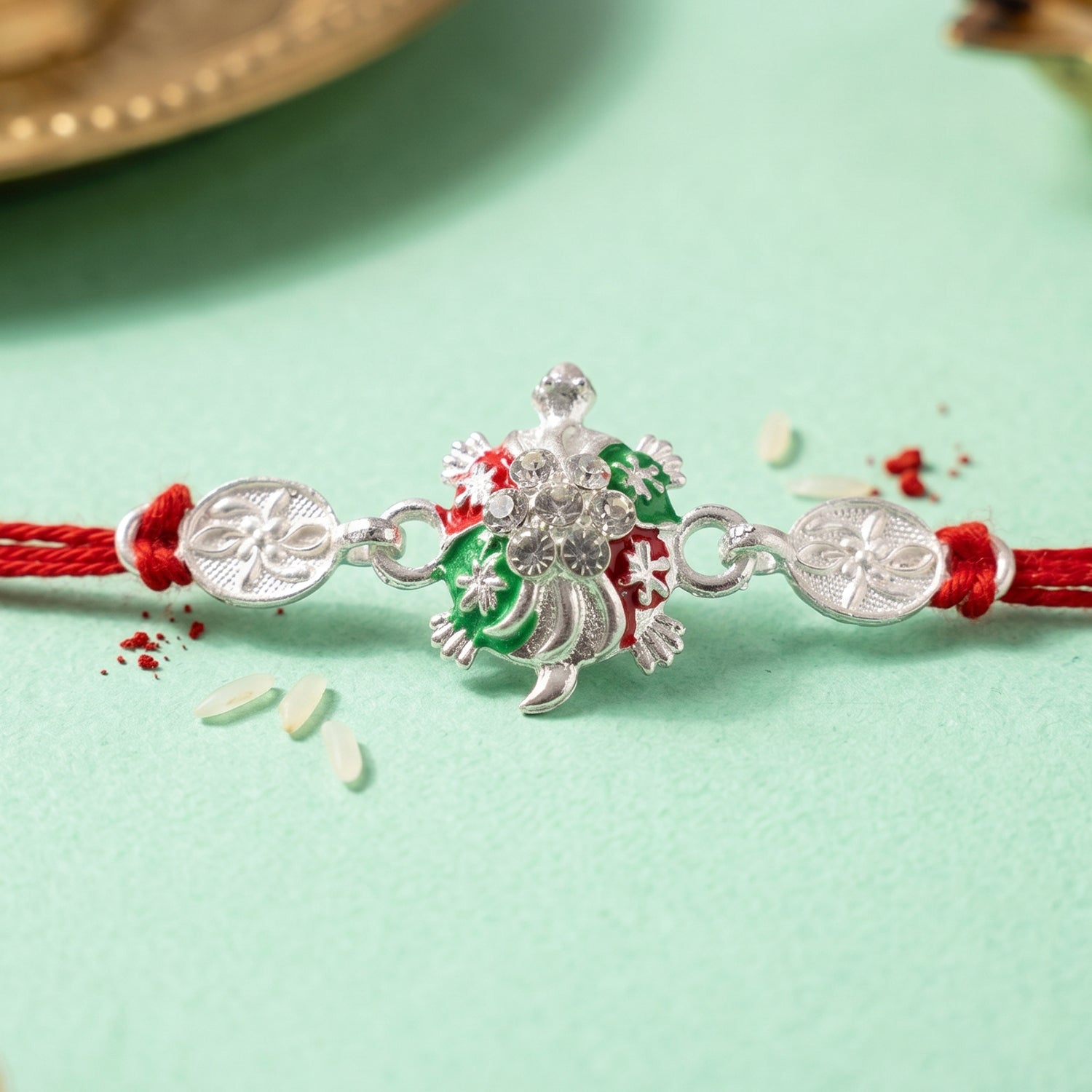 Turtle Rakhi with Red Thread and Crystal Embellishments