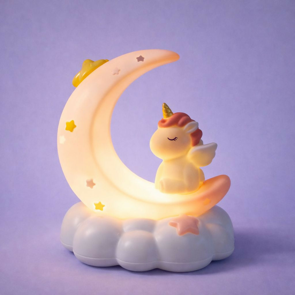A softly glowing unicorn crescent moon night light is displayed on a plain purple surface.
