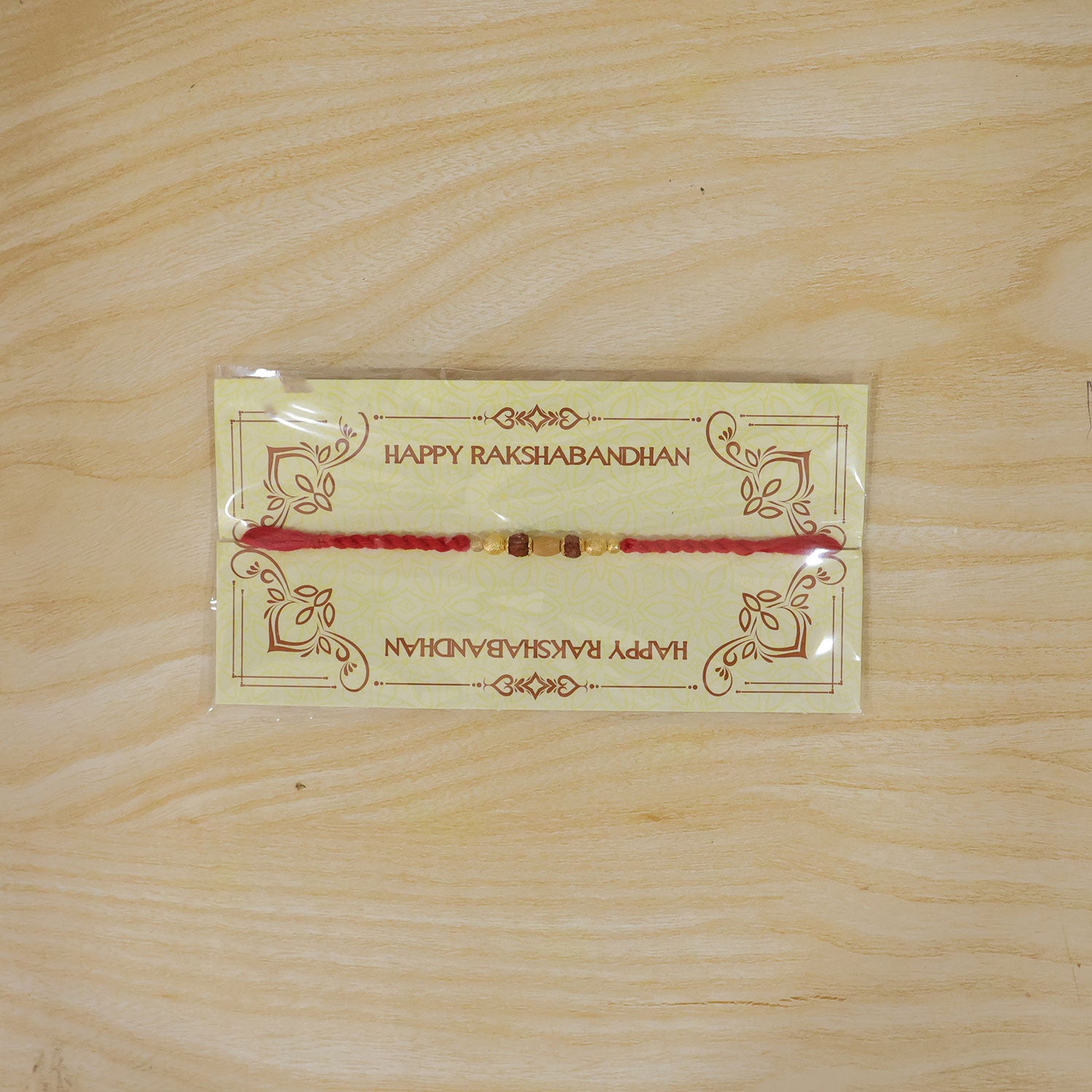 Red Thread Rakhi with a Row of Natural Rudraksha Bead Pendant