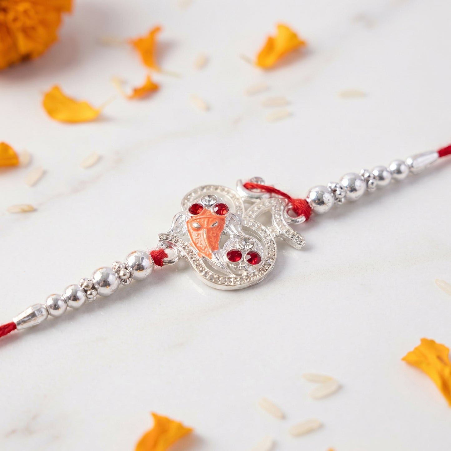 Silver Om Ganesh Rakhi with Red Stones and Metal Bead Chain
