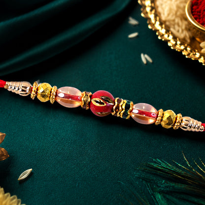 Red Enamel Golden Designer Rakhi with Transparent Beads and Rich Festive Shine