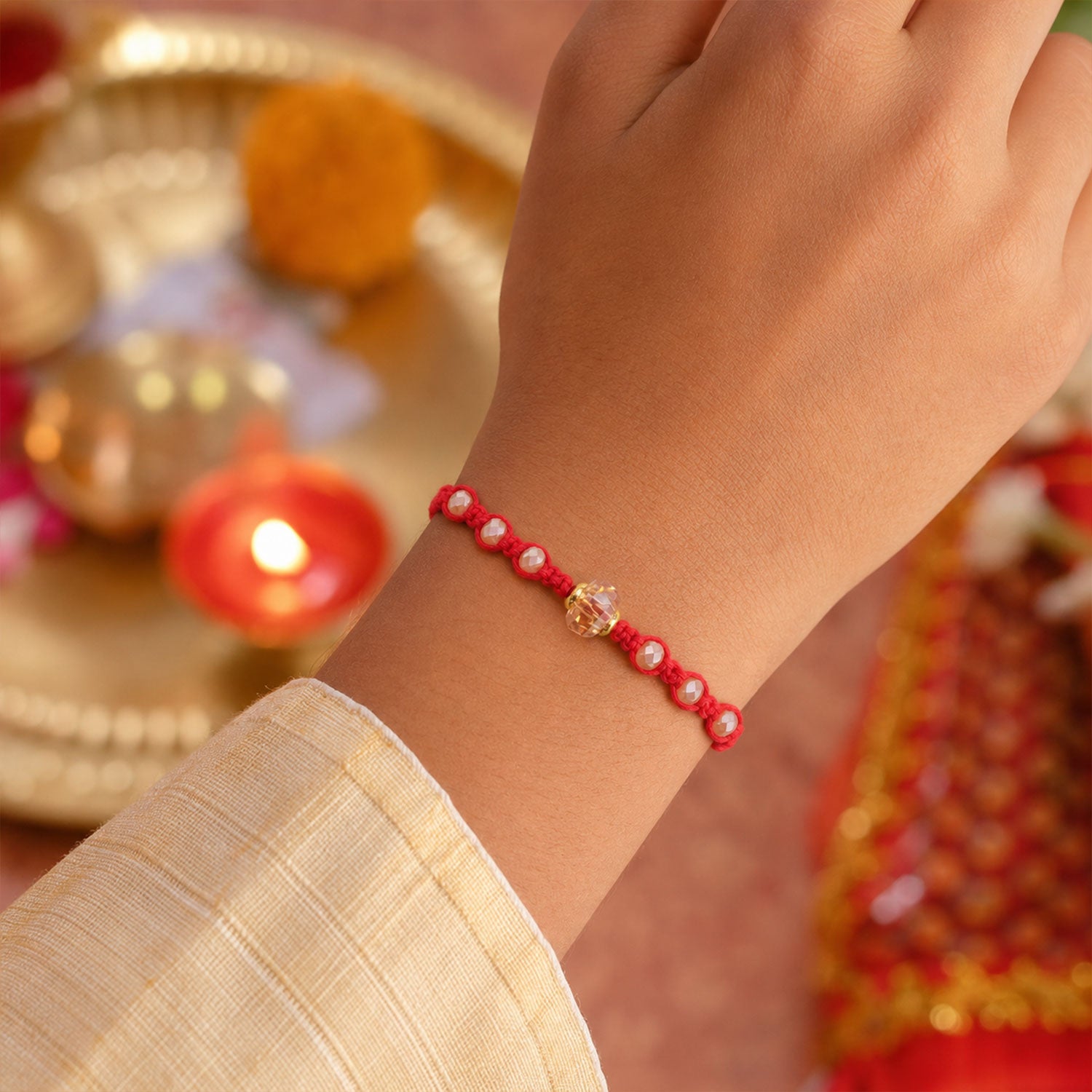 Red Beaded Rakhi with Champagne Crystal Bead and Red Bead Accents