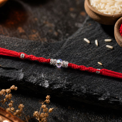 Red Braided Rakhi with a Row of Sparkling Crystal Bead Accents