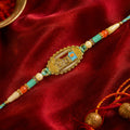 Shiv Script Pendant Rakhi with Teal and Orange Beads