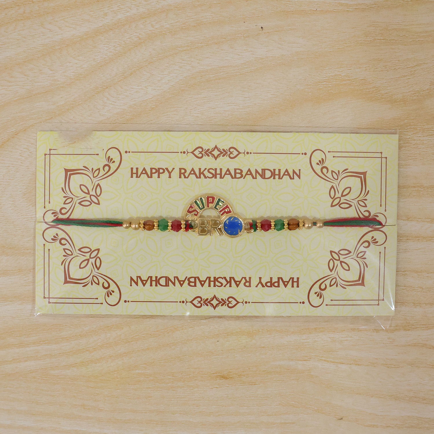 Super Bro Golden Rakhi with Colorful Beads, Blue Charm and Premium Festive Look