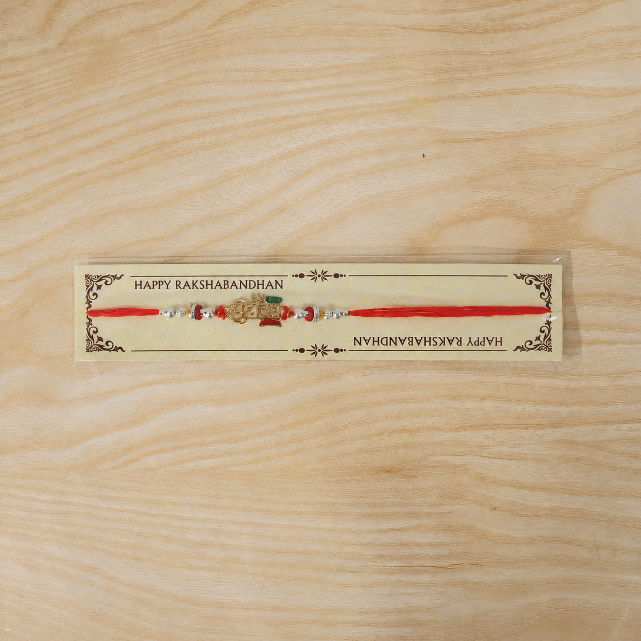 Mahadev Damru Rakhi with Red Green Beads and Pearl Highlights