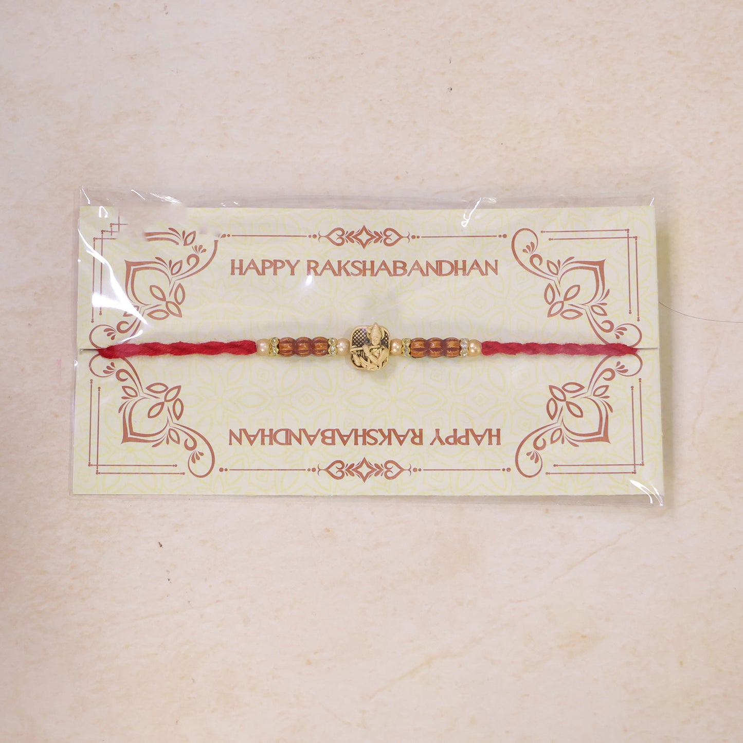 Red Beaded Rakhi with Antique Gold Krishna Charm and Wooden Beads
