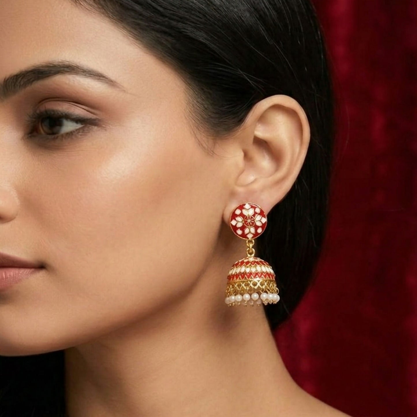 Red floral jhumka earrings highlighting delicate pearl bead hangings