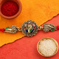 Antique Gold-Toned Peacock Rakhi with Multicolor Enamel, Crystal Accents & Red Thread