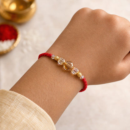 Red Thread Rakhi with Golden and Sparkling Crystal Bead Accents