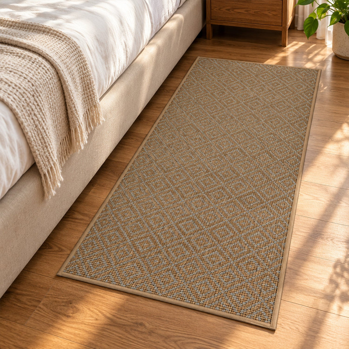 A long, rectangular brown runner mat with a subtle diamond design lies on a wooden floor next to a bed.