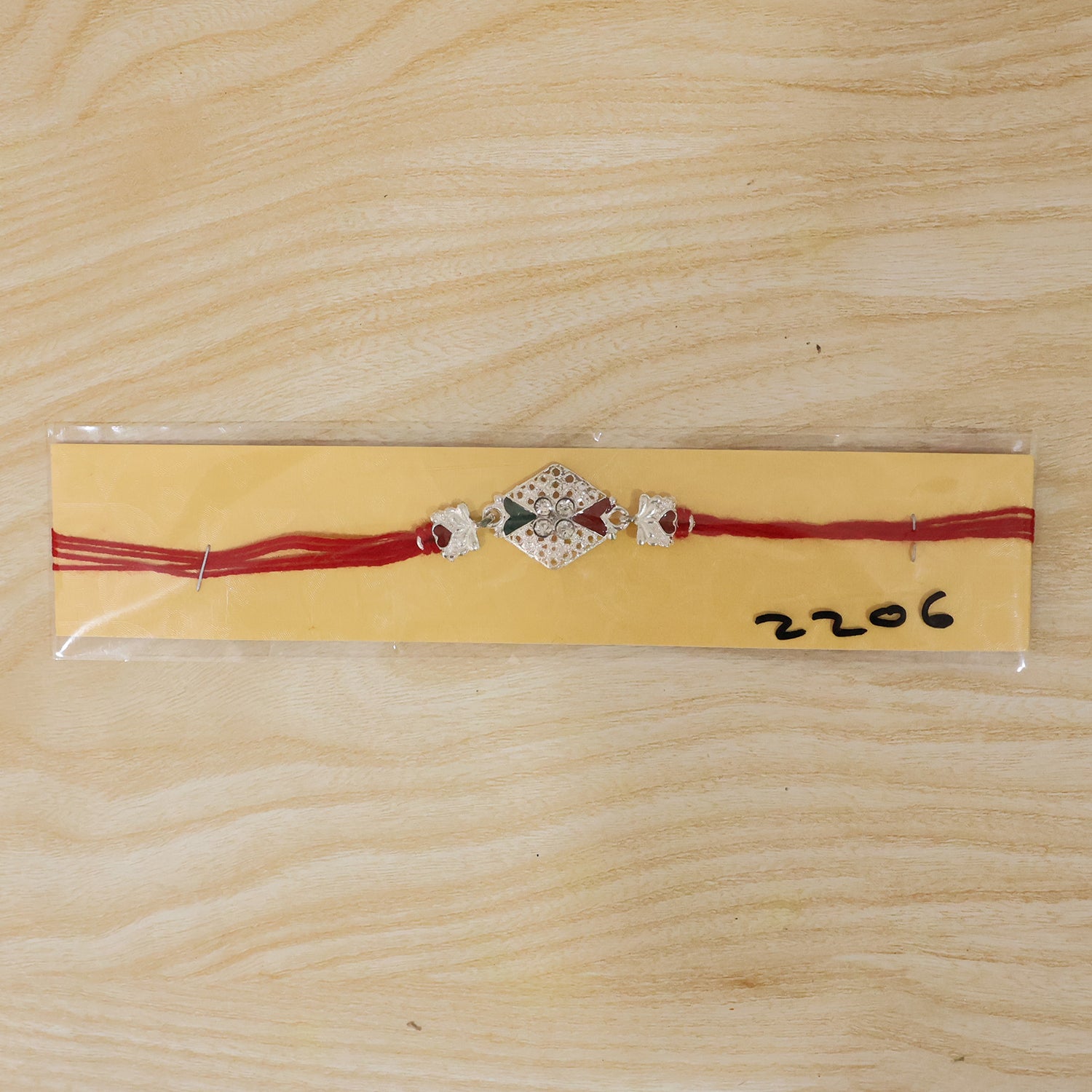 Silver Elephant Charm Rakhi with Red Green Stones and Crystals