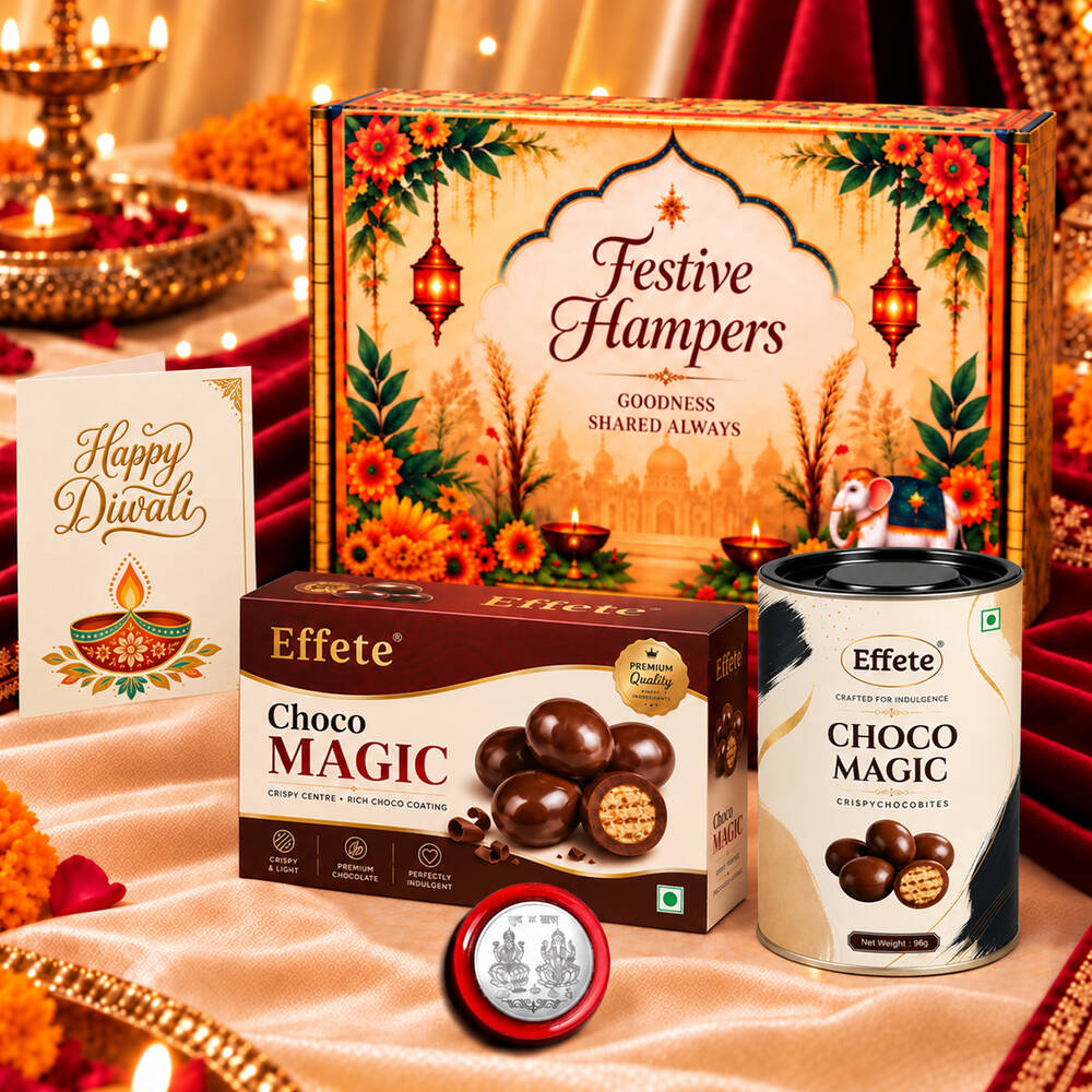 A festive gift box, chocolate box, canister, greeting card, and silver coin on a peach cloth.