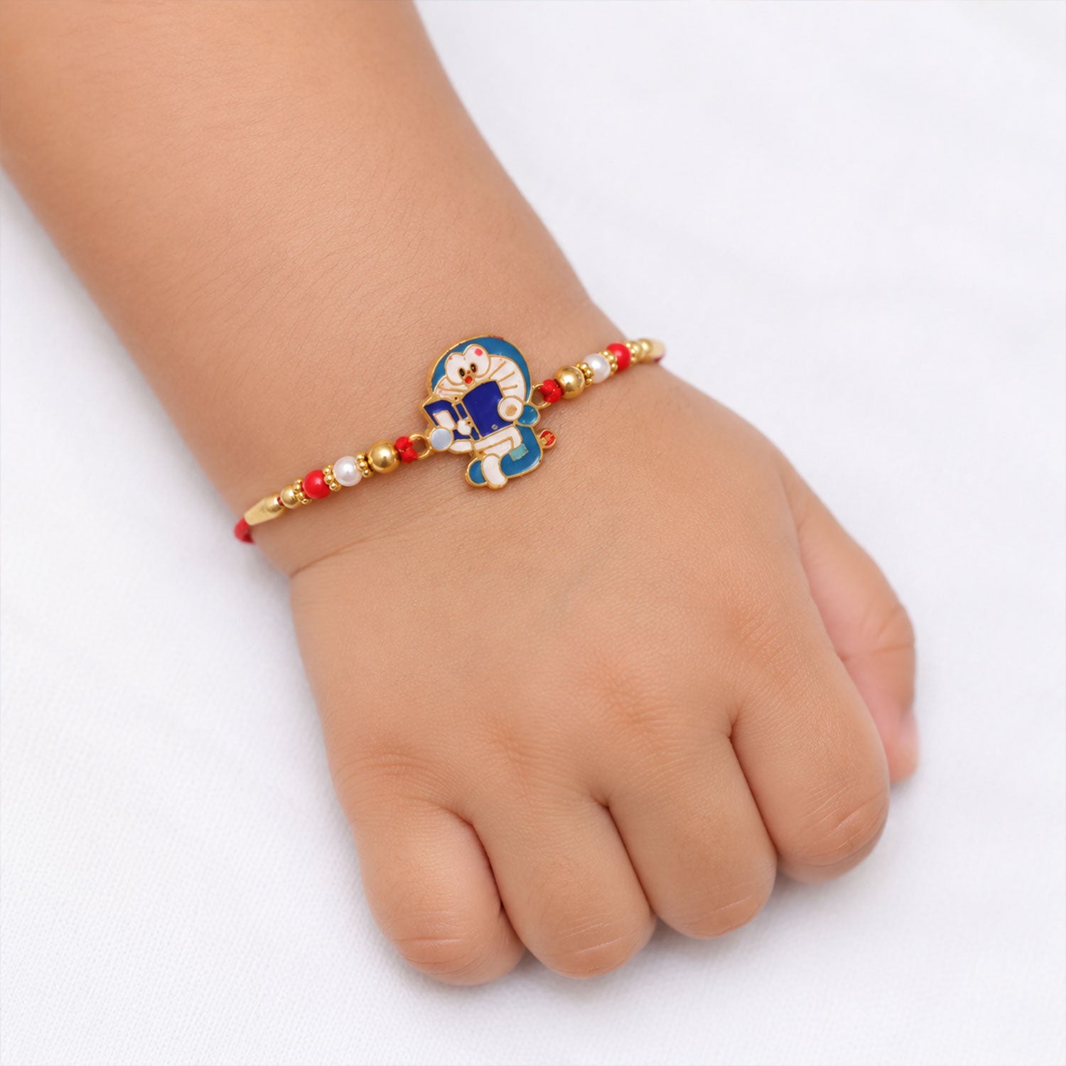 Doraemon Kids Rakhi with Red Gold Beads and Playful Blue Charm