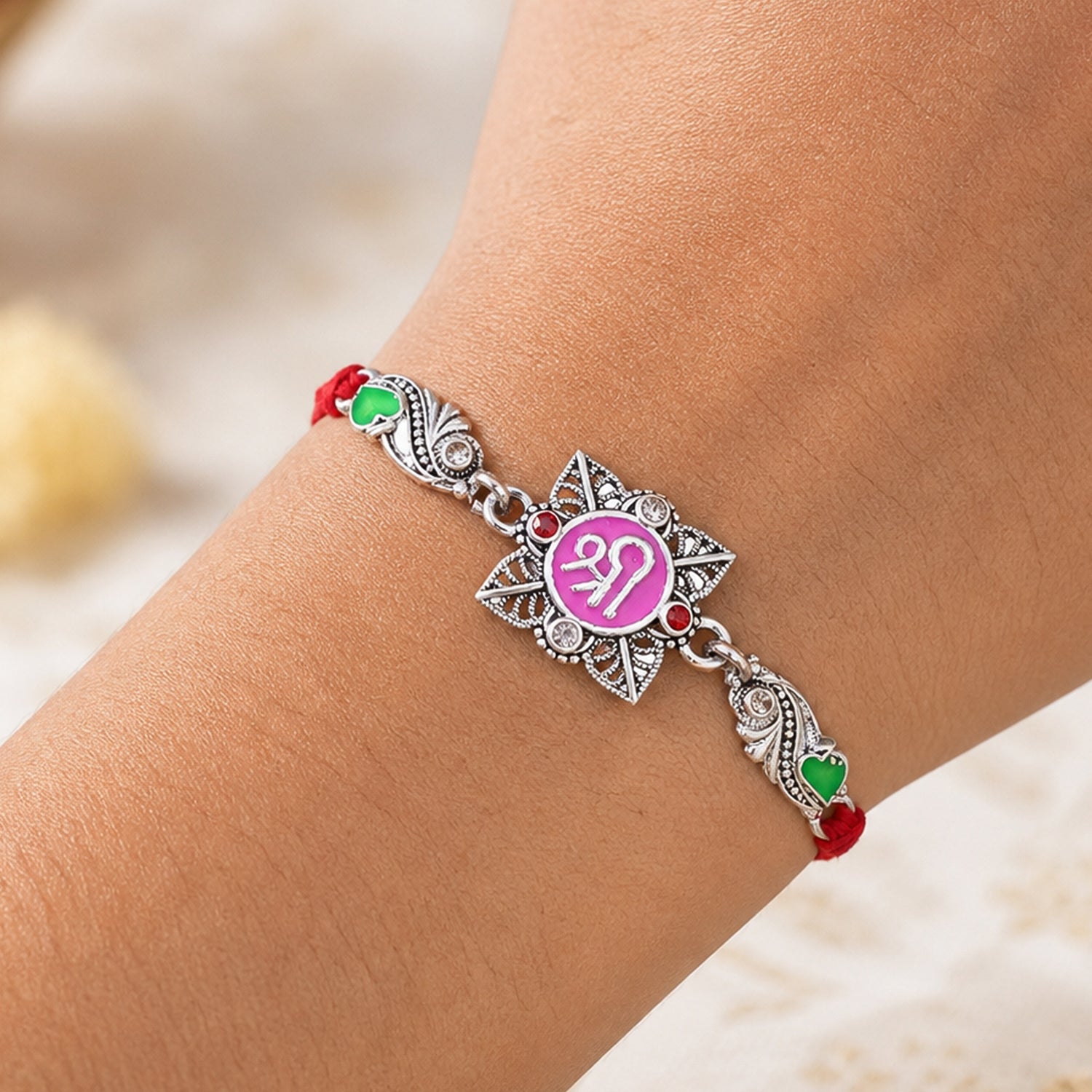 Silver-Toned Shree Rakhi with Pink Enamel, Crystal Accents & Designer Red Thread