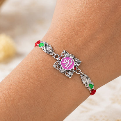 Silver-Toned Shree Rakhi with Pink Enamel, Crystal Accents & Designer Red Thread