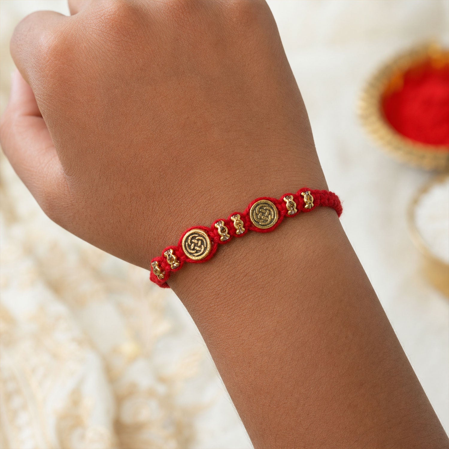 Red Braided Rakhi with a Row of Antique Gold Coin-Style Charms