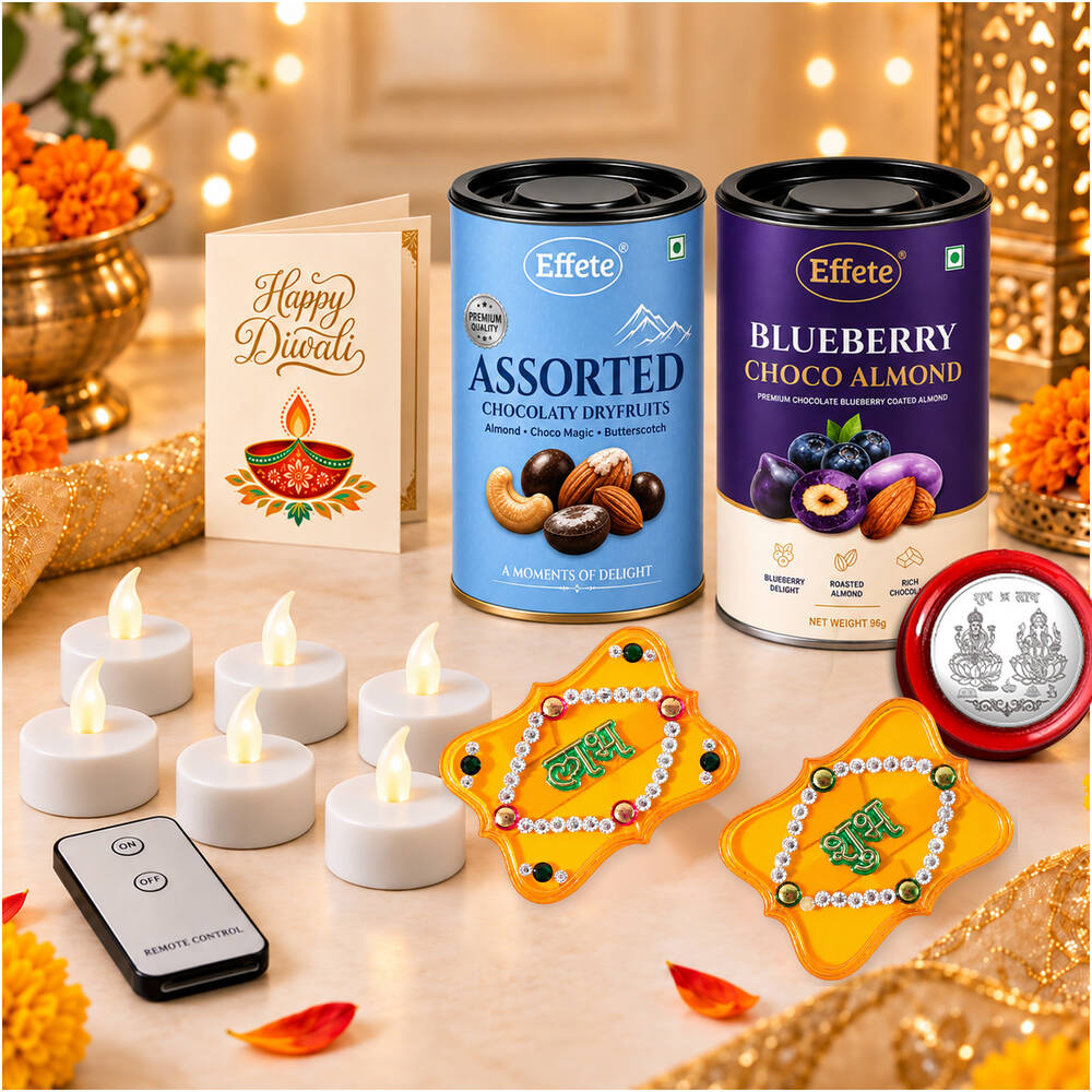 A festive arrangement with a Diwali card, two chocolate tins, six white LED tealights, a remote, two yellow decor items, and