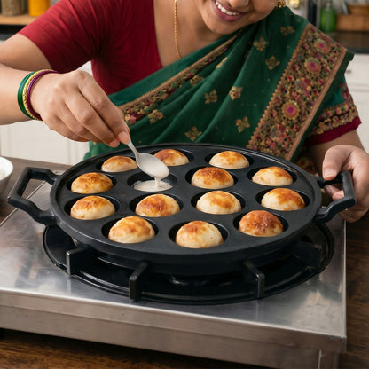 Side view of cast iron appam patra pan with handles