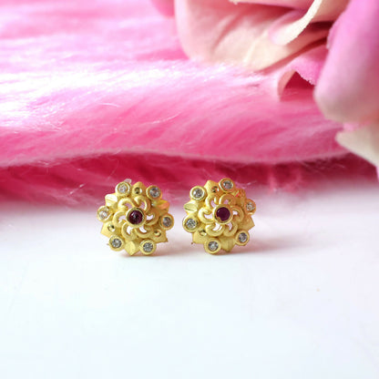 Front view of gold floral stud earrings with multi-stones