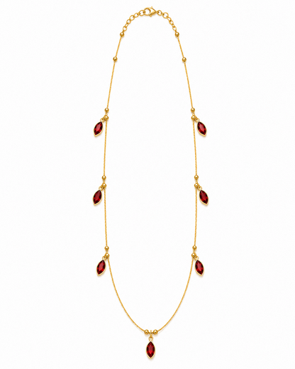 A simple studio shot of the gold-plated chain necklace, showcasing all red marquise-cut crystal pendants evenly spaced along