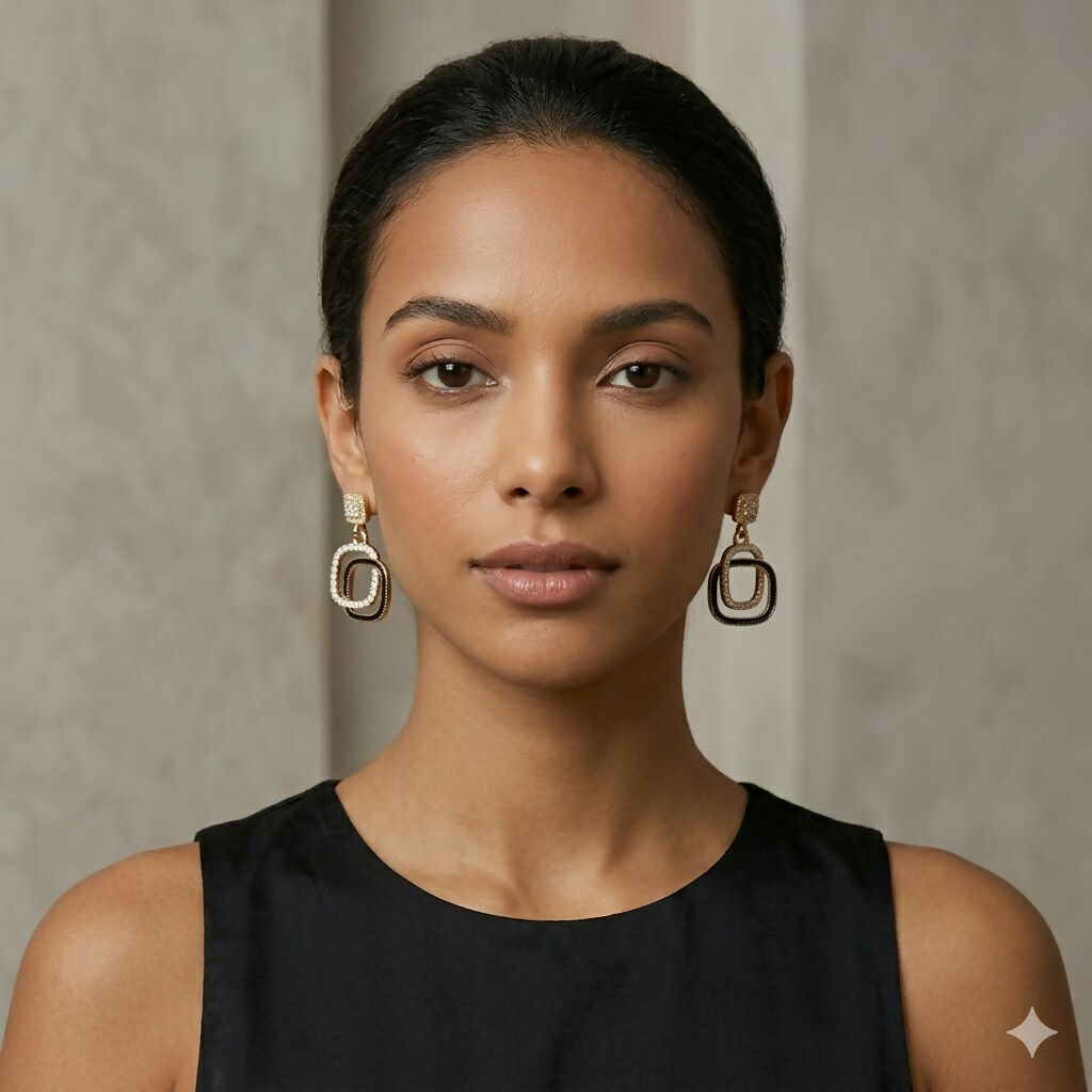 Black stone gold plated drop earrings worn with casual outfit