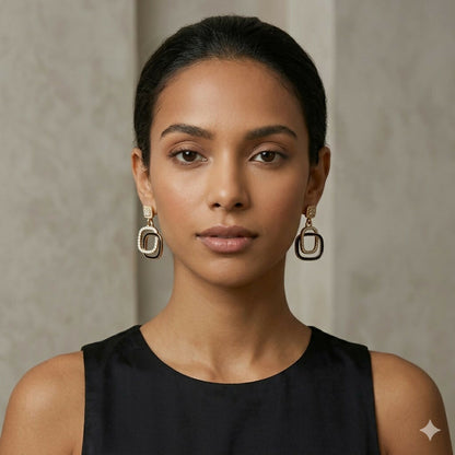 Black stone gold plated drop earrings worn with casual outfit