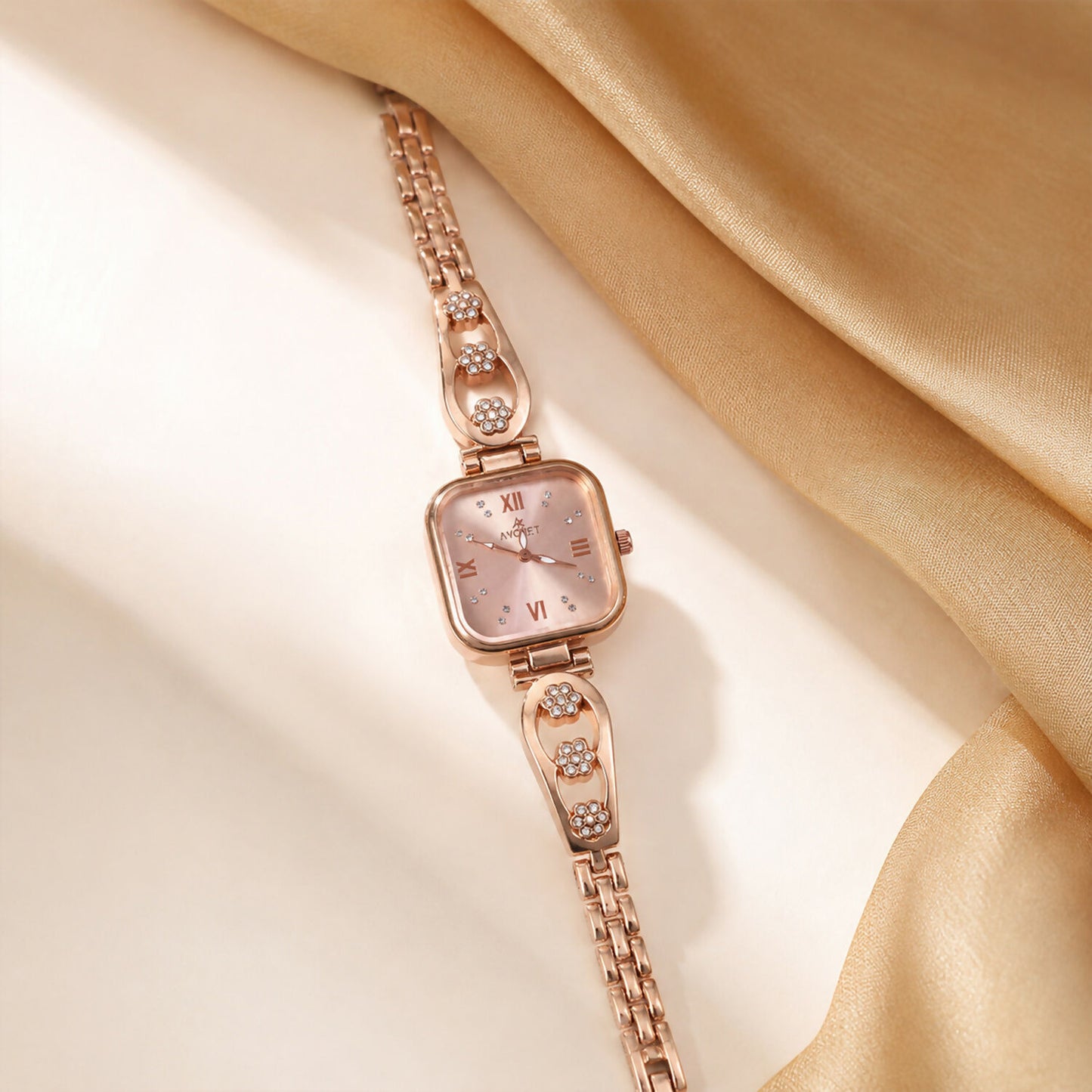 Close-up of the square dial and intricate floral design on the rose gold watch band.