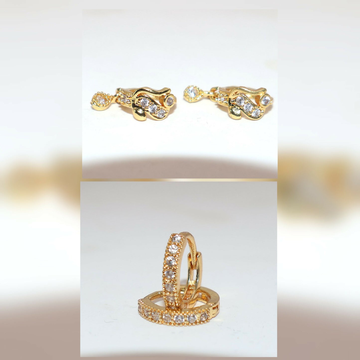 Close-up view of gold-plated cubic zirconia mini huggie earrings worn on hand
