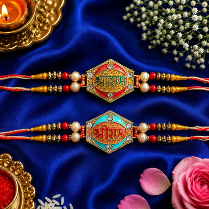 Two designer Rakhis with pearl beads and gold and rose gold finish, one with a green center and one with a blue center, on a