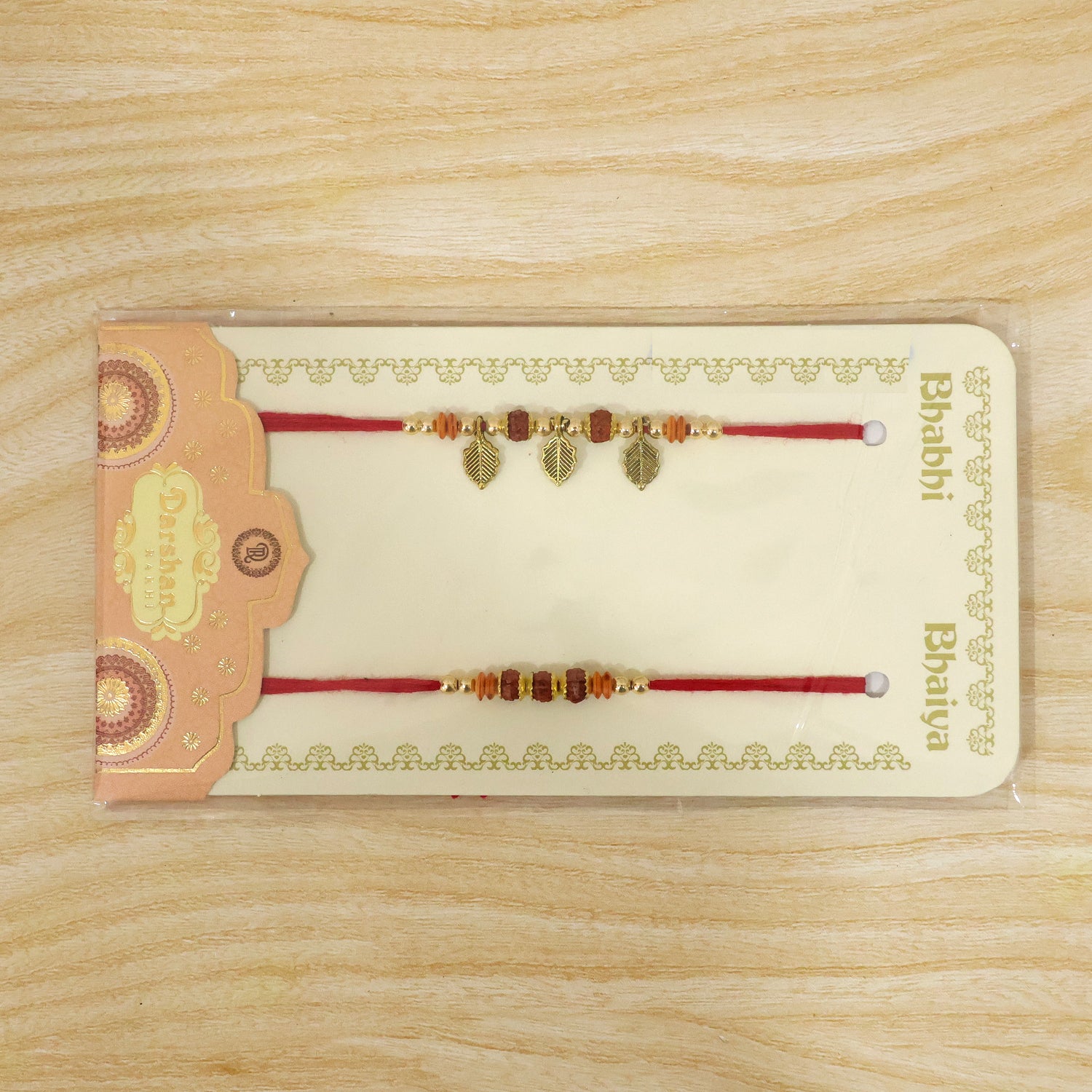 Couple Rakhi Set with Rudraksha Beads, Orange Spacers and Leaf Charms