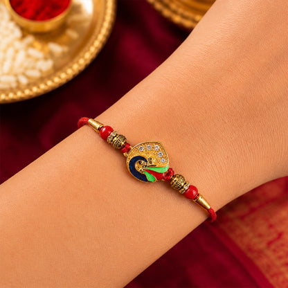Peacock Feather Rakhi with Red Beads and Cute Mor Charm