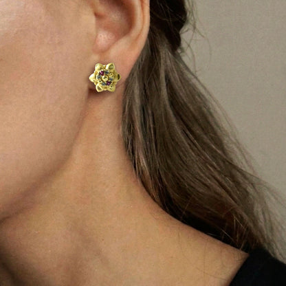 Elegant gold stud earrings with traditional motifs, perfect for gifting