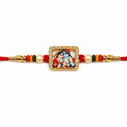 A close-up of the red thread bracelet shows a gold-toned square Radha Krishna charm with a crystal border and pearl accents.