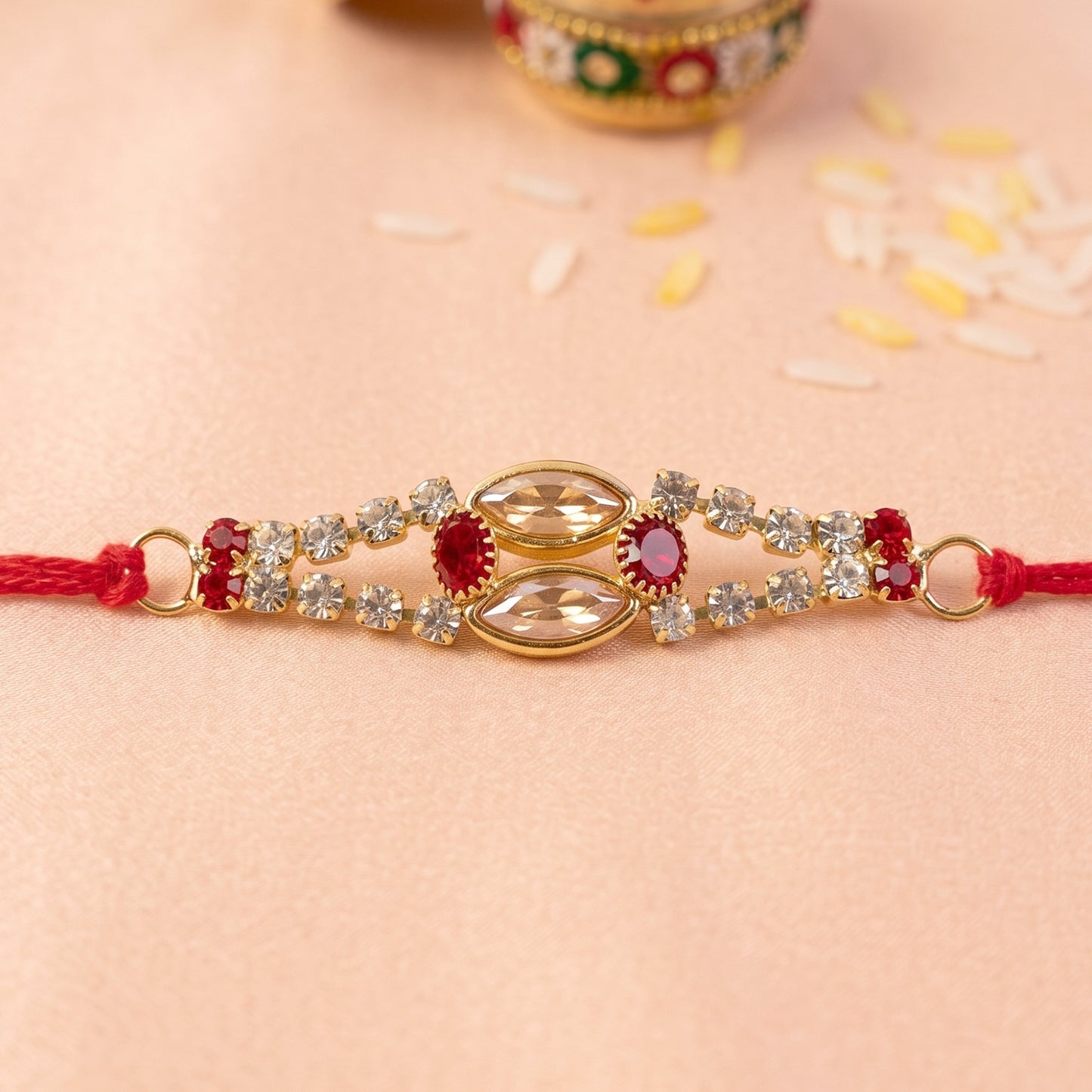 Oval Kundan Bracelet Rakhi with Red Blue Stones and Crystal Line