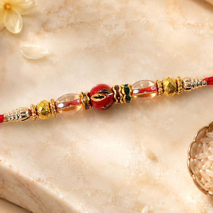 Red Enamel Golden Designer Rakhi with Transparent Beads and Rich Festive Shine