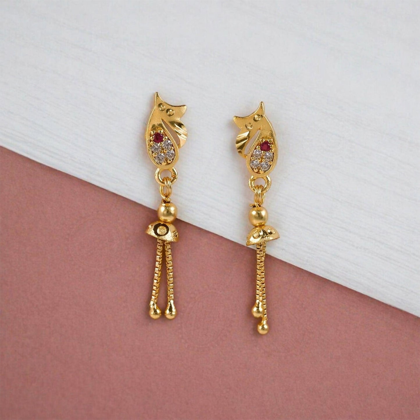 Earrings displayed showing intricate gold casting details
