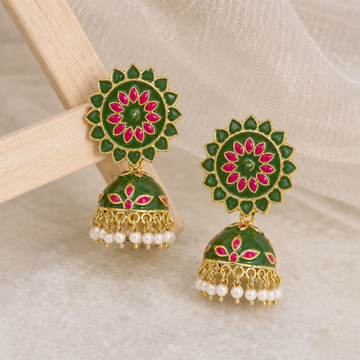 Side view of mahendi and pink floral jhumka earrings