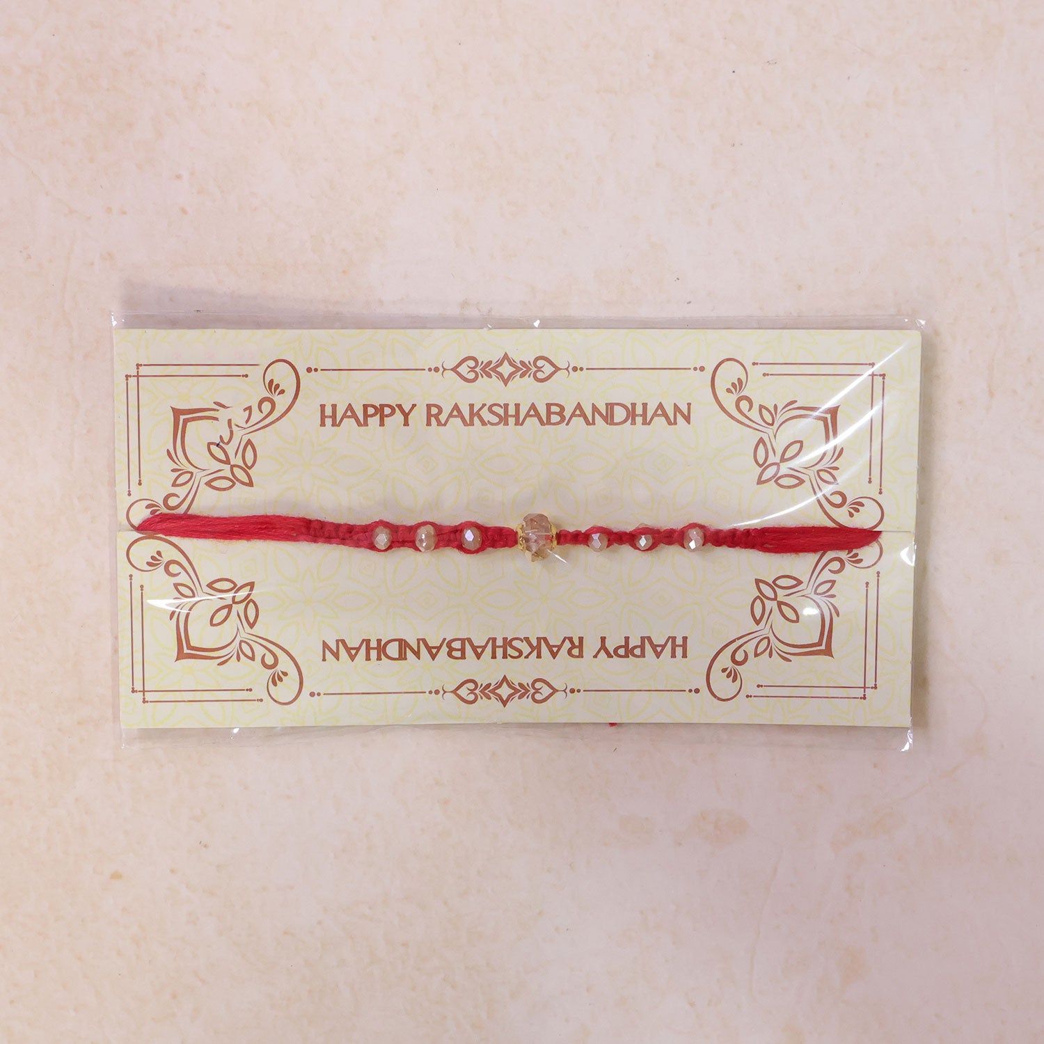 Red Beaded Rakhi with Champagne Crystal Bead and Red Bead Accents