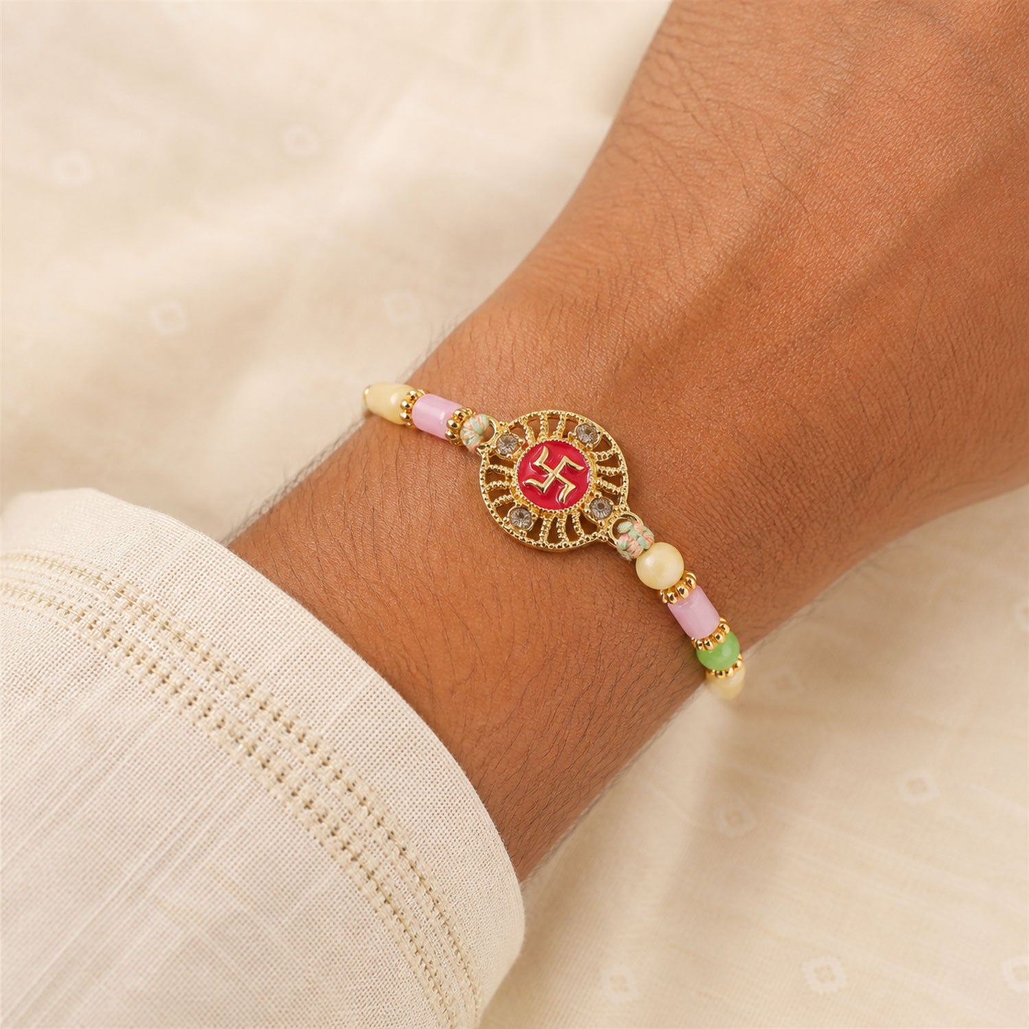 Swastik Pendant Rakhi with Kundan Stones and Pastel Beads