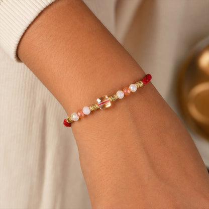 Red Thread Rakhi with Peach and Rose-Toned Crystal Bead Pendant
